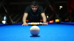 A customer setting up the balls on a pool table